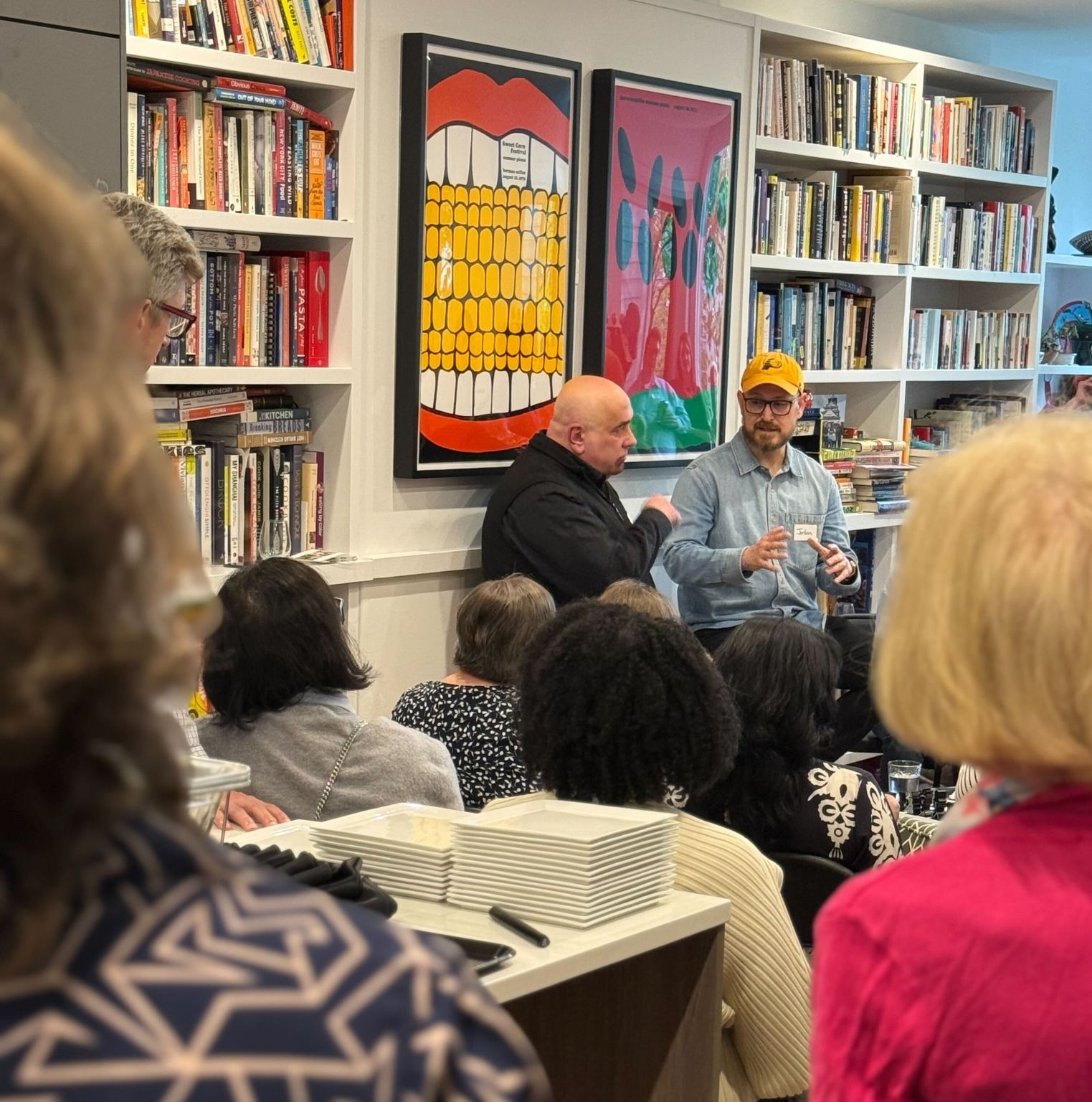 Matt Mansfield interview Jordan LaFlure of The Onion in a living room surrounded by books and people.